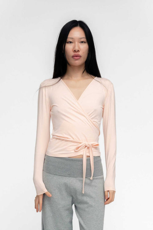 Ballerina wrap topRed's Casual  wearfindmenowthelabelTopThe ballerina wrap top is the perfect layering piece, made out of breathable bamboo jersey. Wear alone or layer with your favorite lightweight pieces. 
Fit Details ✿BALLERINA WRAP TOP IN POWDER PINK
